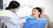 asian-female-patient-sitting-chair-with-open-mouth-dentist-looking-her-teeth